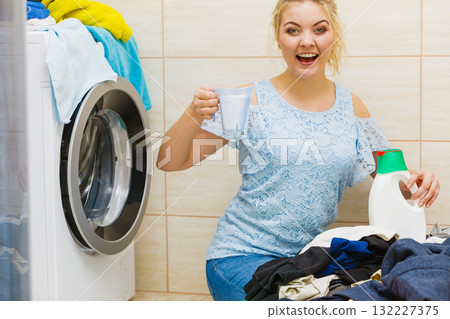 Girl doing laundry choose best detergent. Girl doing laundry choose best detergent. 132227375