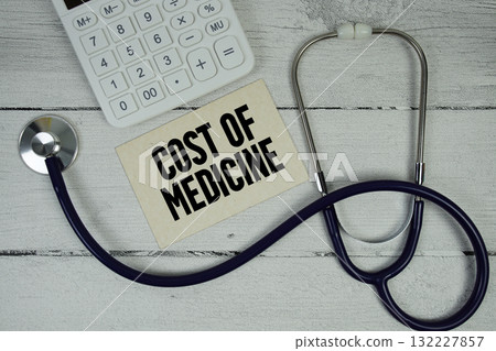 Cost of Medicine text with Stethoscope and calculator on wooden background Cost of Medicine text with Stethoscope and calculator on wooden background 132227857