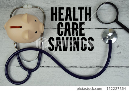 Health Care Savings text with Stethoscope and magnifying glass on wooden background 132227864