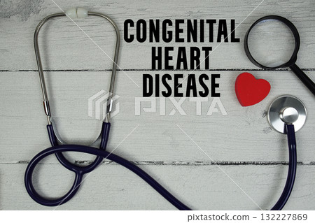 Congenital Heart Disease text with Red heart, Magnifying glass and Medical Stethoscope on wooden background 132227869