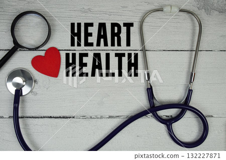 Heart Health text with Red heart, Magnifying glass and Medical Stethoscope on wooden background Heart Health text with Red heart, Magnifying glass and Medical Stethoscope on wooden background 132227871
