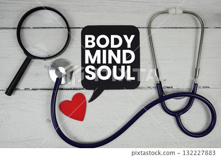 Body Mind Soul text with Red heart, Magnifying glass and Medical Stethoscope on wooden background Body Mind Soul text with Red heart, Magnifying glass and Medical Stethoscope on wooden background 132227883