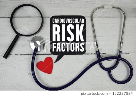 Cardiovascular Risk Factors text with Red heart, Magnifying glass and Medical Stethoscope on wooden background 132227884