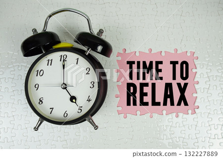 Time To Relax text with alarm clock on pink background Time To Relax text with alarm clock on pink background 132227889