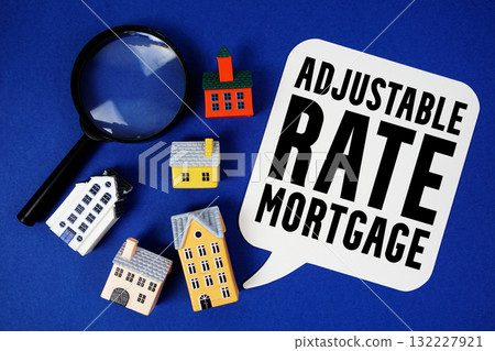 ARM Adjustable-Rate Mortgage text with house models and magnifying glass on blue background ARM Adjustable-Rate Mortgage text with house models and magnifying glass on blue background 132227921
