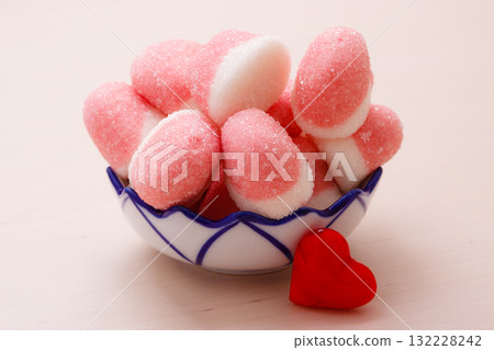 Pink jellies or marshmallows with sugar in bowl 132228242