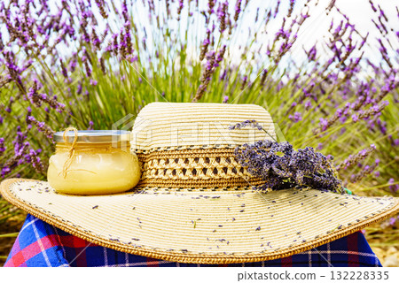 Summer hat and jar with honey at lavender field. Holidays in France. 132228335