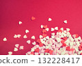 Scattered heart-shaped topping sugar. Stylish and cute background decoration. Feelings. Confectionery ingredients. 132228417
