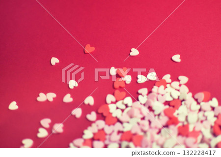 Scattered heart-shaped topping sugar. Stylish and cute background decoration. Feelings. Confectionery ingredients. Scattered heart-shaped topping sugar. Stylish and cute background decoration. Feelings. Confectionery ingredients. 132228417