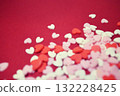 Scattered heart-shaped topping sugar. Stylish and cute background decoration. Feelings. Confectionery ingredients. 132228425
