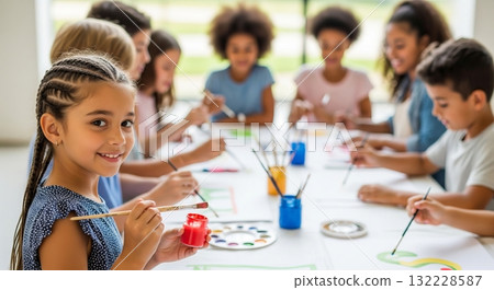 Young diverse children painting together in an art class, smiling and enjoying creativity. concept of creative expression, teamwork, childhood education 132228587