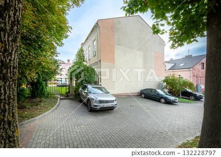 Cozy Courtyard with Parked Cars and Old Building Cozy Courtyard with Parked Cars and Old Building 132228797