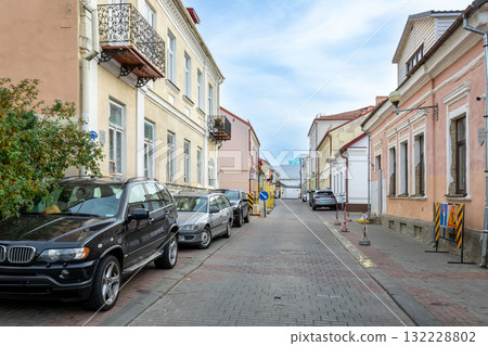 Historic Street with Old Buildings and Parked Cars 132228802