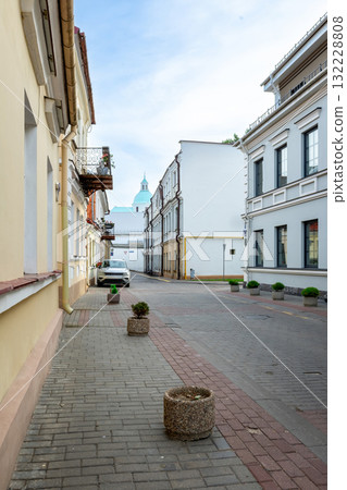 Narrow old city street with historical buildings and church dome Narrow old city street with historical buildings and church dome 132228808