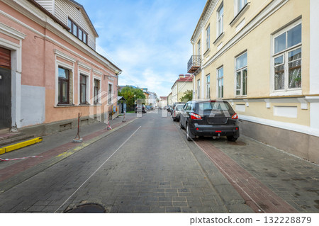 Narrow old street with colorful residential buildings and parked cars on sunny day Narrow old street with colorful residential buildings and parked cars on sunny day 132228879
