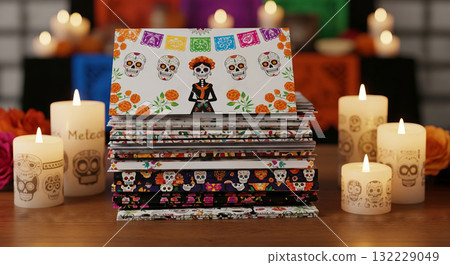 Stack of colorful Day of the Dead greeting cards with sugar skulls and marigold decorations surrounded by candles. Concept of Dia de los Muertos celebration, Mexican holiday stationery 132229049