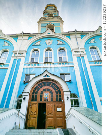 Church of Ascension with vibrant blue facade and wooden entrance, showcasing architectural beauty Church of Ascension with vibrant blue facade and wooden entrance, showcasing architectural beauty 132229257