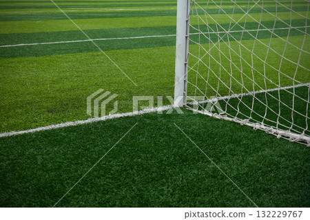 Close up of a soccer goal net on a well-maintained field 132229767