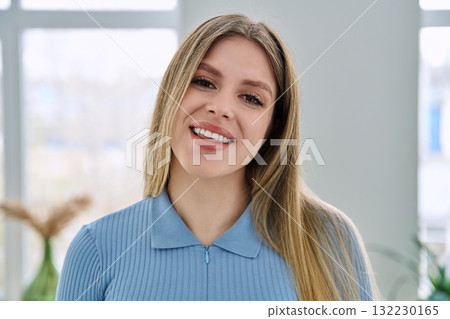 Headshot portrait of young happy woman looking at camera 132230165