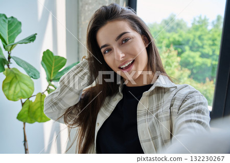 Close-up selfie portrait of teenage female looking at web camera Close-up selfie portrait of teenage female looking at web camera 132230267
