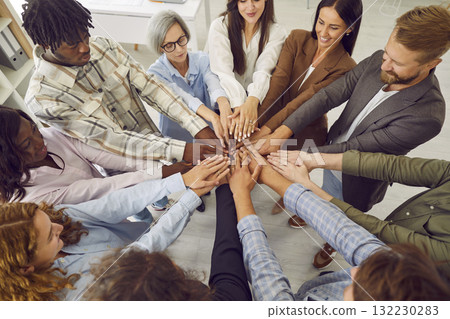 Top view photo of diverse business people putting their arms together in stack. 132230283