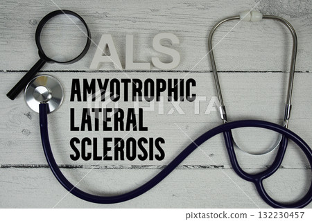 ALS Amyotrophic Lateral Sclerosis text with Stethoscope on wooden background 132230457