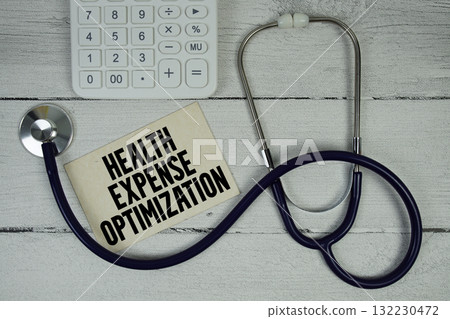 Health Expense Optimization text with Stethoscope and calculator on wooden background Health Expense Optimization text with Stethoscope and calculator on wooden background 132230472