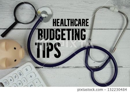 Healthcare Budgeting Tips text with Stethoscope and calculator on wooden background 132230484