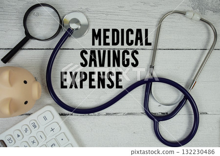 Medical Expense Savings text with Stethoscope and calculator on wooden background 132230486