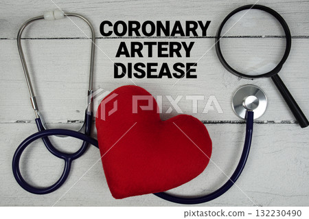Coronary Artery Disease text with Red heart, Magnifying glass and Medical Stethoscope on wooden background Coronary Artery Disease text with Red heart, Magnifying glass and Medical Stethoscope on wooden background 132230490