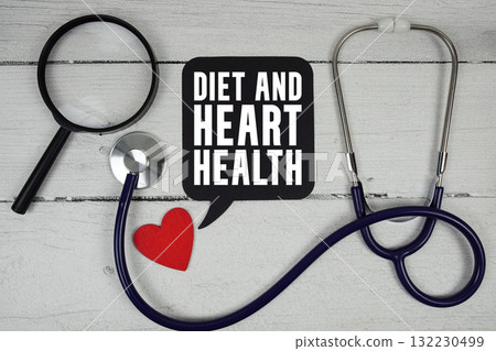 Diet and Heart Health text with Red heart, Magnifying glass and Medical Stethoscope on wooden background. 132230499