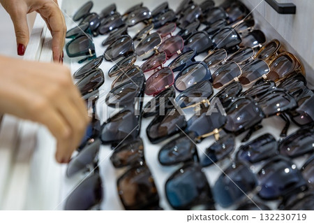 Choosing Sunglasses from a Display Choosing Sunglasses from a Display 132230719