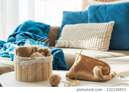 Knitting Setup with Yarn Basket and Cozy Couch in Sunlight Knitting Setup with Yarn Basket and Cozy Couch in Sunlight 132230853