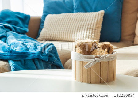 Knitting Setup with Yarn Basket and Cozy Couch in Sunlight 132230854