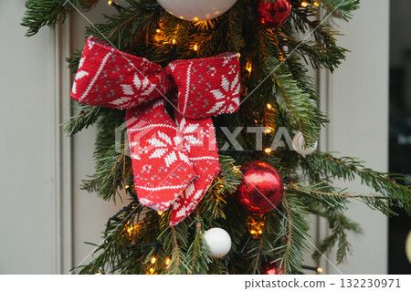 Red bow on a Christmas tree branches 132230971