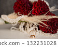 Romantic Wedding Rings and Deep Red Dahlia Bouquet with Pampas Grass. Gold Bands, Floral Arrangement, Love, Commitment, Celebration Style. 132231028