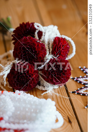 Deep Burgundy Dahlias with Pearl Strands: Rustic Wedding Florals, Crafting Details, Dark Floral Arrangement, Textured Wood Background, Bohemian Style Deep Burgundy Dahlias with Pearl Strands: Rustic Wedding Florals, Crafting Details, Dark Floral Arrangement, Textured Wood Background, Bohemian Style 132231049