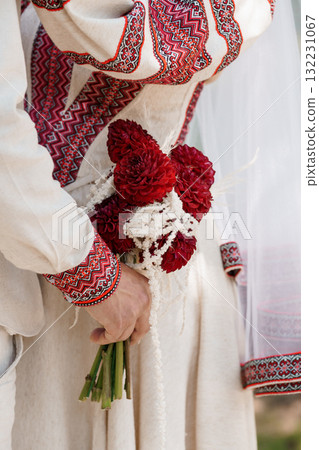 Traditional Slavic Wedding Bouquet: Red Dahlias, Embroidered Linen Dress, White Lace, Cultural Ceremony, Rustic Style, Close-Up Photography 132231067