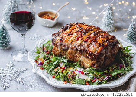 Delicious Roasted Meat Dish Served on a Bed of Fresh Greens With Sauce and Red Wine 132231591