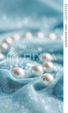 Glimmering Pearls Scattered Over Soft Blue Fabric Create an Elegant and Serene Display 132231722