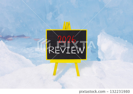 2026 Review symbol. Concept words 2026 Review on beautiful black blackboard. Beautiful blue lake Baikal ice background. Business and 2026 review concept. Copy space. 132231980
