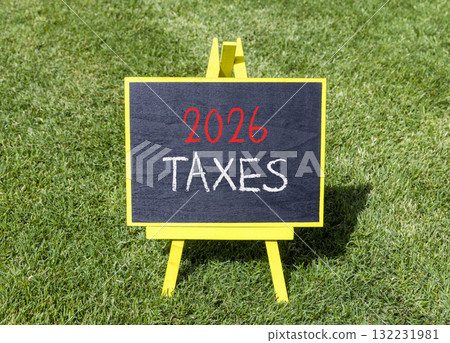 2026 taxes new year symbol. Concept words 2026 taxes on beautiful black blackboard. Beautiful green grass background. Business and 2026 taxes new year concept. Copy space. 132231981