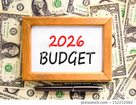 2026 Budget symbol. Concept words 2026 Budget on beautiful wooden picture frame. Beautiful dollar bills background. Black pen. Dollar bills. Business and 2026 budget concept. Copy space. 132232002