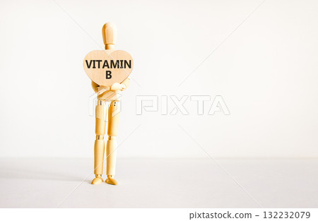 Vitamin B symbol. Concept words Vitamin B on beautiful wooden heart. Doctor's model. Beautiful white background. Copy space. Medical healthy lifestyle Vitamin B concept. Vitamin B symbol. Concept words Vitamin B on beautiful wooden heart. Doctor's model. Beautiful white background. Copy space. Medical healthy lifestyle Vitamin B concept. 132232079