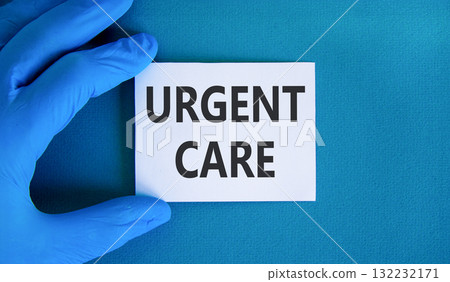 Urgent care symbol. Concept words Urgent care on beautiful white card. Doctor's hand in blue medical glove. Beautiful blue background. Medical healthy lifestyle urgent care concept. 132232171