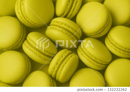 Monochrome chartreuse macarons layered as a vibrant background 132232262