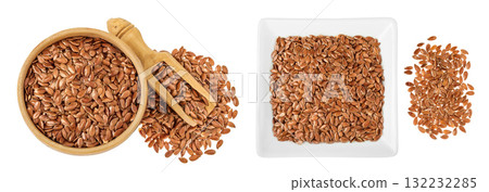 flaxseed in wooden and ceramic bowl isolated on white background. Top view. Flat lay 132232285