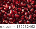 Fresh Ruby Red Pomegranate Seeds Scattered on a Smooth Surface 132232462