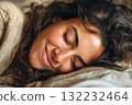 Woman Peacefully Sleeping With a Content Smile in a Cozy Indoor Setting 132232464