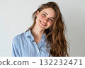 Young Woman With Long Hair Smiling Warmly Against a Light Background 132232471
